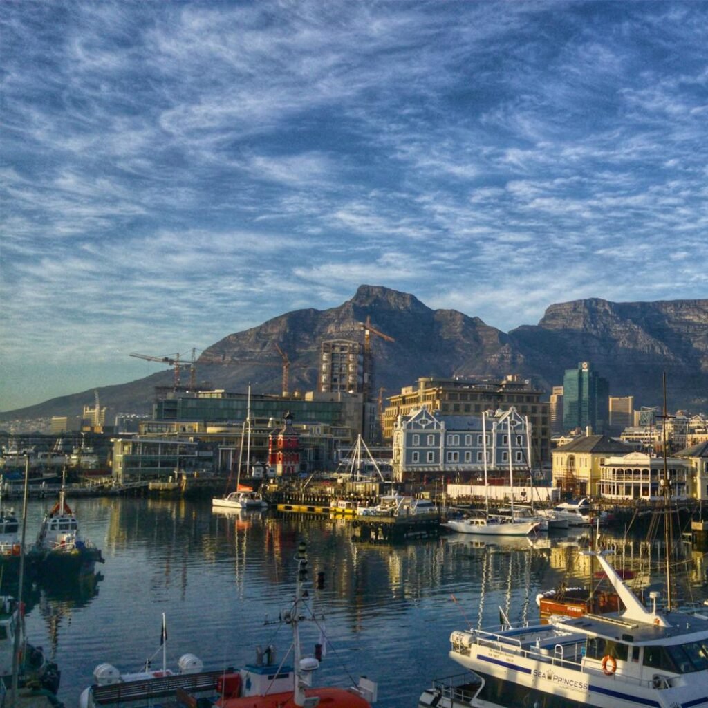 Stunning view of Cape Town harbor with boats and iconic Table Mountain backdrop.