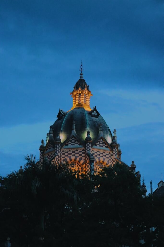 Stunning view of Medellín architecture with the illuminated dome against a twilight sky.